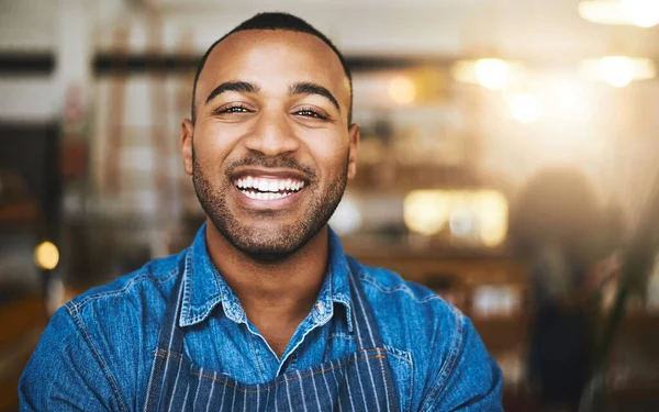 Coffee shop, restaurant and portrait of black man waiter for service, working and happy in cafe. Small business owner, barista startup and confident male worker smile in cafeteria ready to serve.