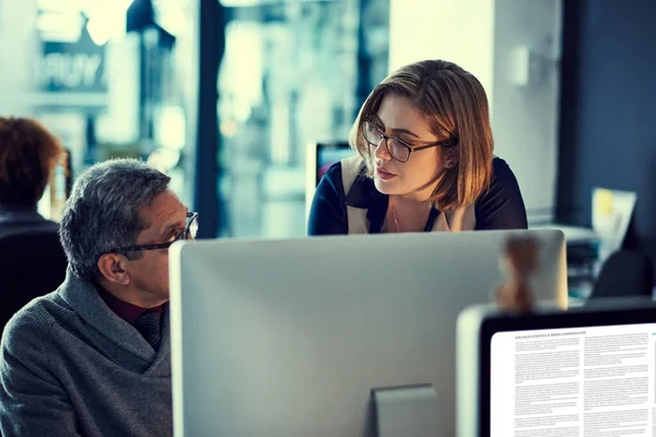 stock image Focused on making great things happen together. two businesspeople working late in an office