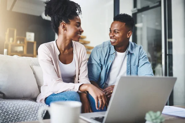 stock image Quality time is connecting time. a happy young couple using a laptop together on the sofa at home