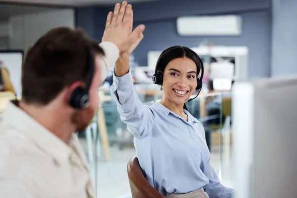 stock image Success, colleagues with celebration and high five at their desk in a modern office at workplace. Teamwork or collaboration, partner and call center agents with handshake for support or motivation.