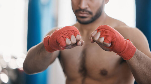 Sports, boxing and hands of man punch in gym for training, workout and exercise for mma fight. Fitness, body builder and closeup of male athlete ready for boxer competition, practice and performance.