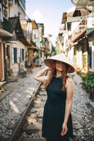 stock image Travel to seek adventure and feel alive. a young woman wearing a conical hat while exploring a foreign city