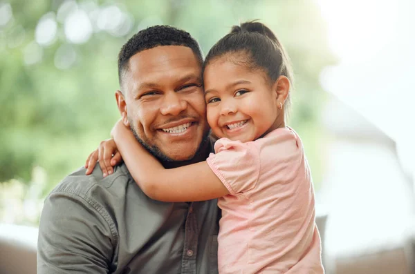 stock image Family, father hug daughter and smile in portrait with bonding, love and care, happiness at home. Happy man with young girl and affection in relationship, people relax together with bond and trust.