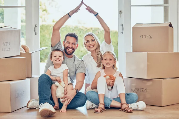 Portrait of happy family, new house and roof hands for insurance, safety and future investment in real estate. Moving, boxes and happiness, woman and man with kids in home with property mortgage