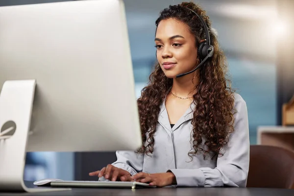 Call center, virtual assistant or woman typing on computer at telecom customer services office job help desk. Microphone, technology or female sales agent consulting or helping in tech support on pc.