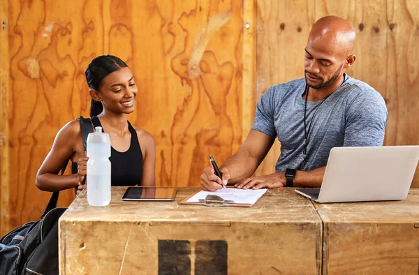 stock image Personal trainer, happy woman or man writing on clipboard for gym membership or sign up for health. Start, fitness contract or girl client talking to instructor for coaching services or application.