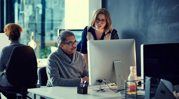 stock image Working hard to maintain their top standards. a group of businesspeople working late in an office