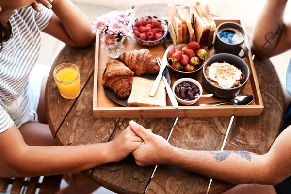 stock image Cafe food, breakfast and couple holding hands for support care, bonding or love on Valentines Day date. Morning, romantic people and brunch tray of croissant, strawberry or bread in coffee shop store.