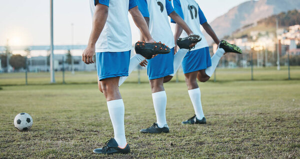 Soccer, team sports and stretching legs on field for fitness, exercise and training outdoor. Football ball, pitch and club for athlete men together for sport competition, wellness and muscle warm up.