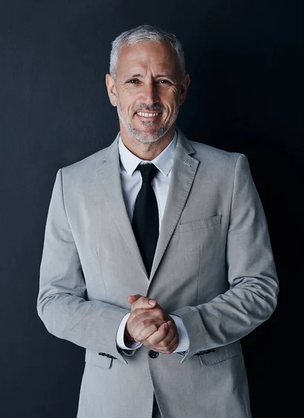 stock image He has everything youd want in someone running your company. Studio portrait of a mature businessman against a dark background