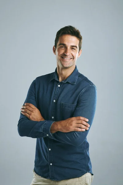 stock image Nothing feels better than feeling confident. a handsome man posing against a grey background