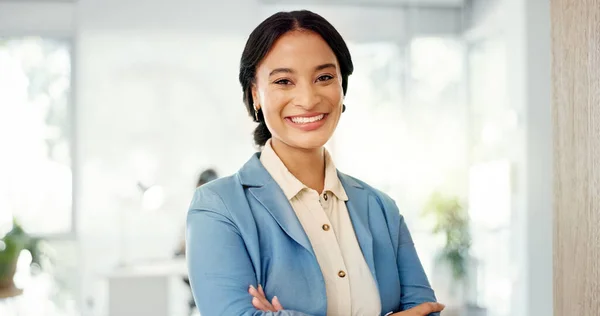 Success, face and business woman in the office with smile, confidence and positive mindset. Happiness, proud and portrait of a professional female employee from Brazil standing in a modern workplace