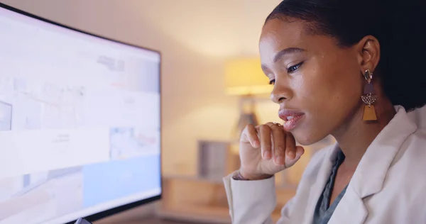 Computer, thinking and business black woman with analysis, market research or data analytics report in night office. Serious, focus and professional person on multimedia tech or desktop screen review.