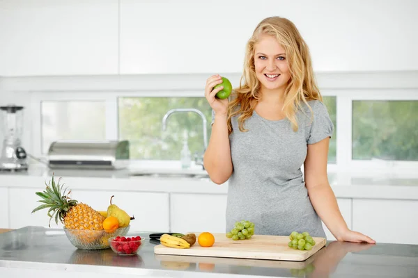 stock image Fruits, apple or portrait of happy woman for healthy lunch or breakfast meal or diet in kitchen at home. Morning snack, smile or vegan girl eating fresh food to lose weight for wellness or gut health.