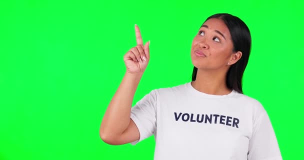 慈善または情報のためのスペースで指を指すボランティア 緑の画面と女性 Tシャツを着た幸せなアジア人は スタジオで非営利プロジェクト Ngoのヘルプや寄付を探しています — ストック動画