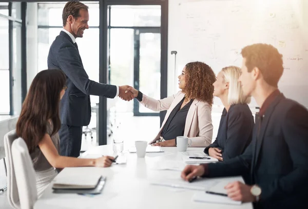 stock image Business people, handshake and meeting for teamwork, agreement or partnership in conference at the office. Businessman shaking hands with woman for b2b, corporate growth or hiring at the workplace.