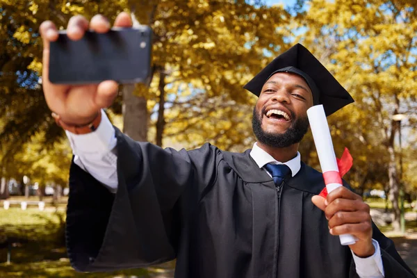 Graduation selfie, success and student or man on university or college campus, profile picture and diploma or certificate. Graduate, photography and african person in park for scholarship celebration.
