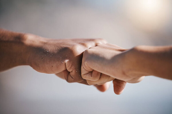 Man, hands and fist bump for teamwork, partnership or unity in solidarity or community in the outdoors. Hand of friends bumping fists together for team goals, support or motivation in collaboration.