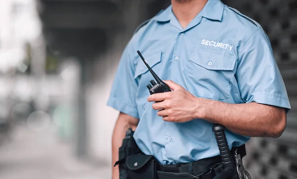 Walkie talkie, security guard or safety officer man on the street for protection, patrol or watch. Law enforcement, hand and duty with a crime prevention male worker in uniform in the city.