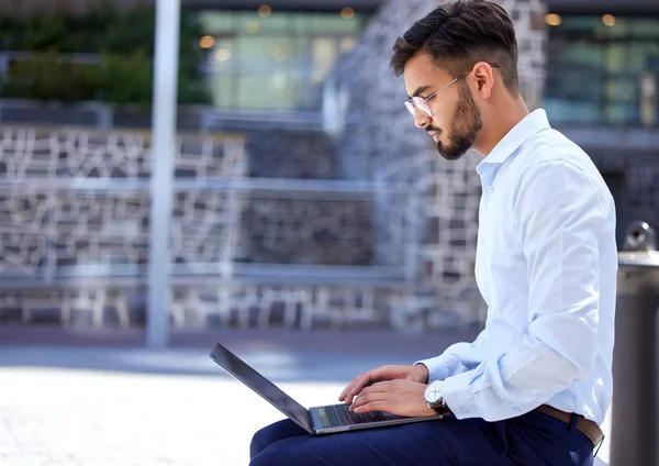 stock image Entrepreneur, business and man with a laptop, outdoor and typing with connection, digital software and planning. Male person, employee and consultant with a pc, city and writer with a new project.