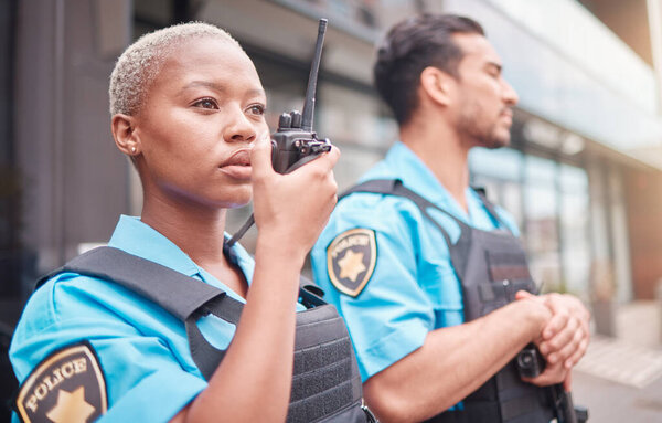 Police, radio and patrol with a black woman officer outdoor on a city street for law enforcement. Walkie talkie, communication and a female security guard talking during crime prevention for safety.