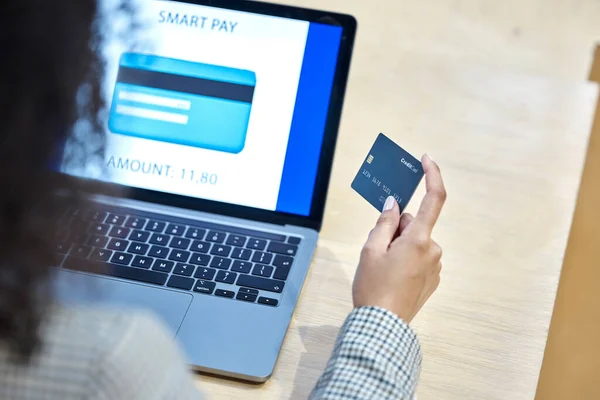 stock image Hand, credit card and laptop for woman in office with payment, online shopping and deal at desk from back. Entrepreneur, cyber security and computer with e commerce, discount or password on internet.