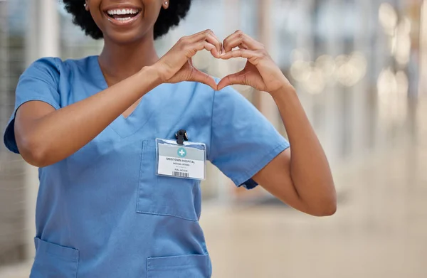 stock image Woman, nurse and heart hands for love, healthcare or passion in cardiology at the hospital. Hand of happy female person or medical professional show loving emoji, symbol or shape icon at the clinic.