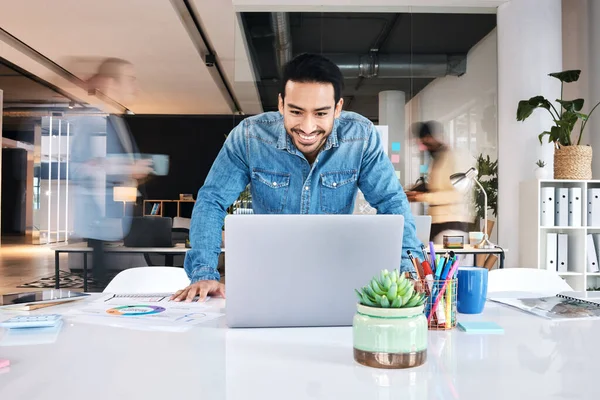stock image Laptop, happy and asian business man in office positive results, report or feedback, reading or email. Smile, good news and male designer online for creative, inspiration or idea in coworking space.