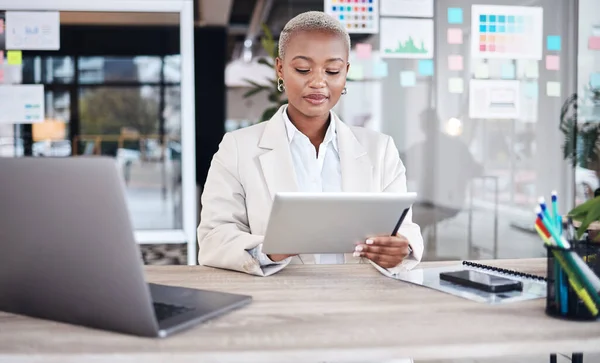 stock image Laptop, business and black woman in office on tablet for research, website and browse internet. Corporate, connection and female person on digital tech working on online project, report and review.