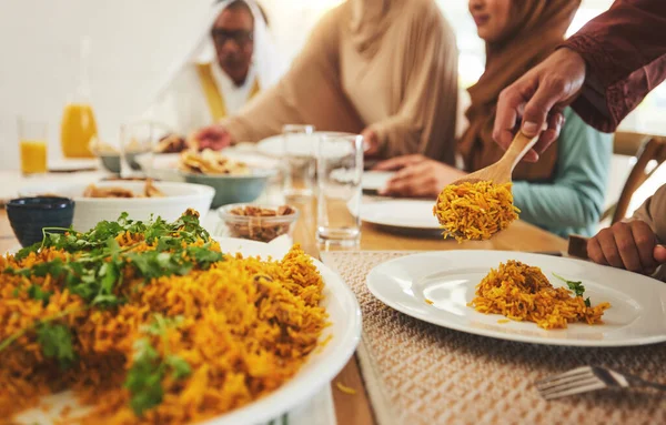 stock image Food, closeup and muslim with big family at table for eid mubarak, Islamic celebration and lunch. Ramadan festival, culture and iftar with people eating at home for fasting, islam or religion holiday.