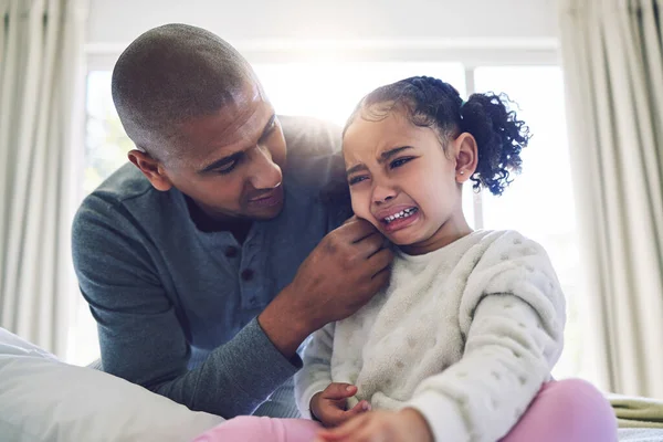 Father, crying girl kid and comfort with talk, care and support with love, bonding and help in family home. Dad, sad daughter and empathy with chat to deal with emotions, fear and anxiety in house.