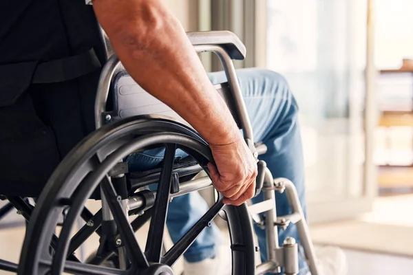 stock image Man, hands and wheelchair for support, hope or travel in healthcare or medicare at home. Closeup of male or person with a disability moving on chair for mobility, surgery or wellness in the house.