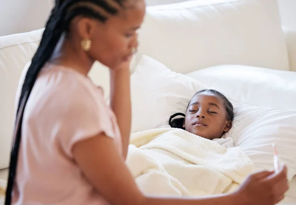 Mother, thermometer and phone call for sick child sleeping in bed with a fever. Black girl kid and a woman together in bedroom for medical risk, health check and help for virus or temperature problem.