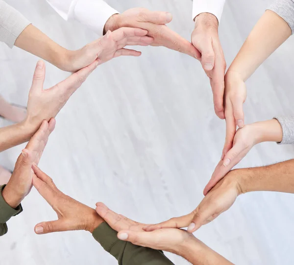 Circle, teamwork and synergy of people hands in collaboration, workflow and group or team building from above. Integration, formation and support, cooperation or community of women and men connection.