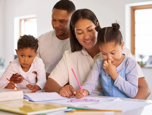 Teaching, parents and children learning in home with mom, dad and education in kindergarten. Couple, helping kids with colouring activity, girl drawing or creative homework project for development.