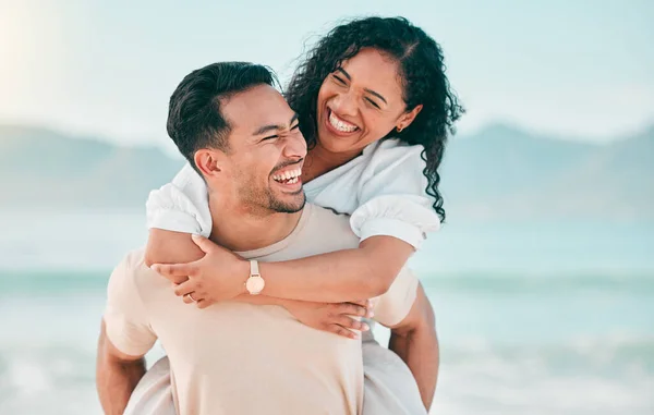 Love, smile and piggyback with couple on beach for travel, summer and vacation together. Peace, happy and relax with man and woman hugging on date for seaside holiday, care and mockup space.