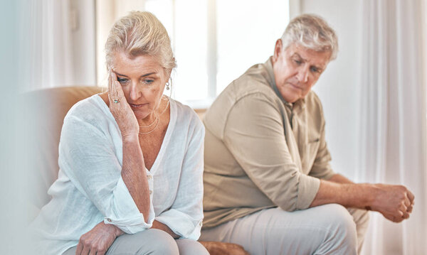 Senior couple, divorce and headache in fight, conflict or argument on the living room sofa at home. Elderly man and frustrated woman in depression, cheating affair or toxic relationship in the house.