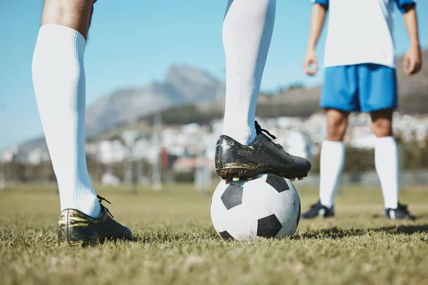 Soccer, legs and foot on ball for match, game or start on the green grass field in nature outdoors. Feet of sports player on football for competition, beginning or getting ready in sport tournament.