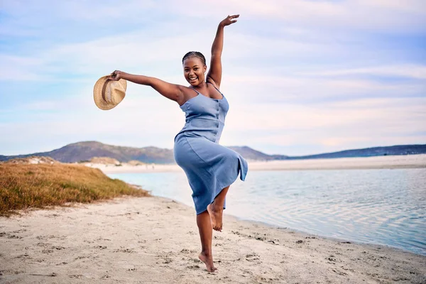 Portrait, excited and black woman dancing, beach and movement with happiness, tropical island or sunset. Face, female person or girl outdoor, travel or seaside holiday for stress relief, dance or joy.