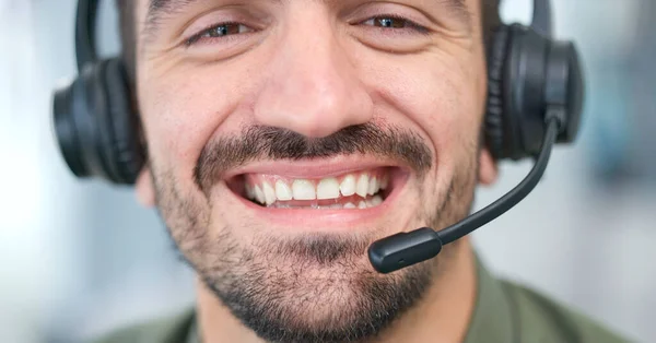 Call center, man face and consultant in virtual communication, business support and ecommerce help. Mouth, headphones and happy IT agent or sales person closeup for customer service and speaking.