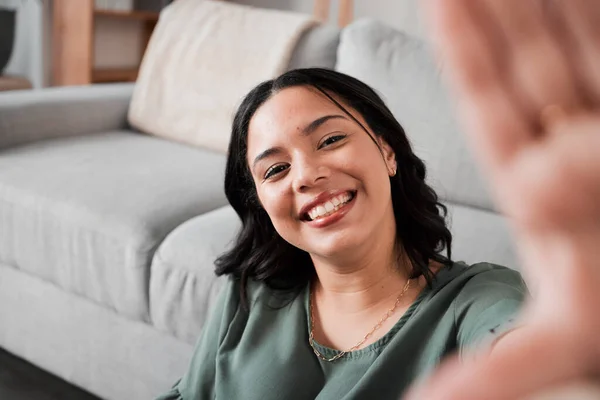 stock image Selfie, happy and portrait of a woman in her living room relaxing, resting or chilling by the sofa. Happiness, smile and young female person from Mexico taking a picture at her modern home apartment