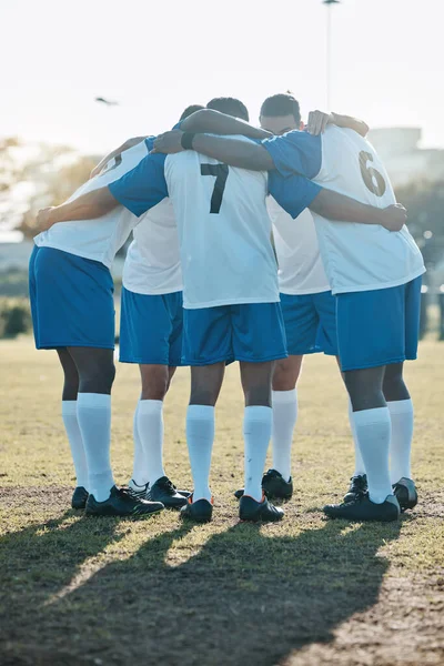 Soccer, support or team in a huddle for motivation, goals or group mission on a field for a sports game. Unity, stadium or football players planning a strategy, exercise or training for fitness match.
