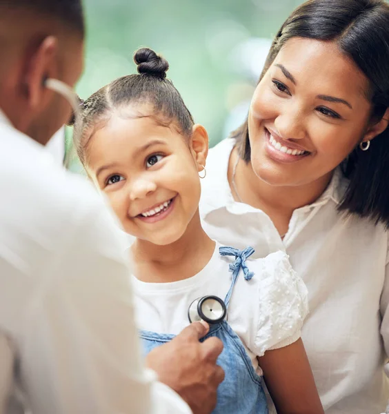 Happy, doctor and mother with girl, healthcare checkup and listen to heartbeat, friendly or consultation. Physician, mama or daughter in the hospital, appointment or stethoscope for diagnosis or care.