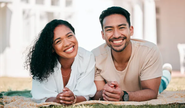 Stock image Portrait, smile and couple on picnic blanket outdoor, bonding and relax together in backyard garden at home. Face, interracial and Asian man and woman with love, happy and quality time on grass lawn.