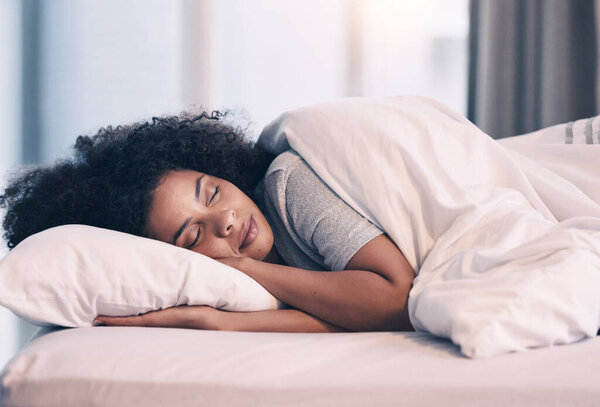 Sleeping, woman and bed with nap at home in morning with rest feeling calm with peace. House, bedroom and tired female person relax and comfortable on a pillow with blanket dreaming over the weekend.