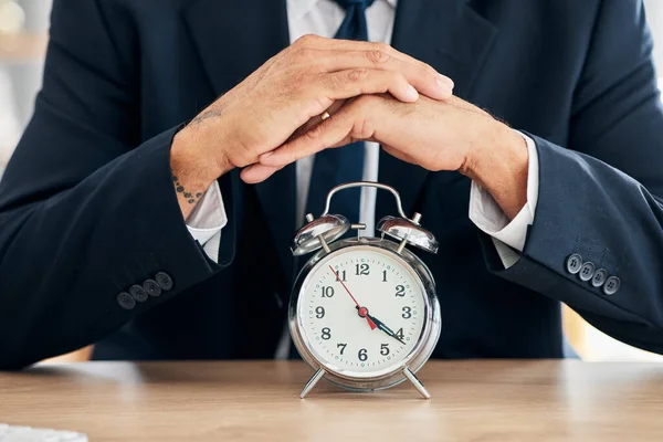 Clock, business man and time management in office for deadline, punctual and busy schedule. Hands of professional person or broker working at desk with alarm, reminder and timer for goals and agenda.