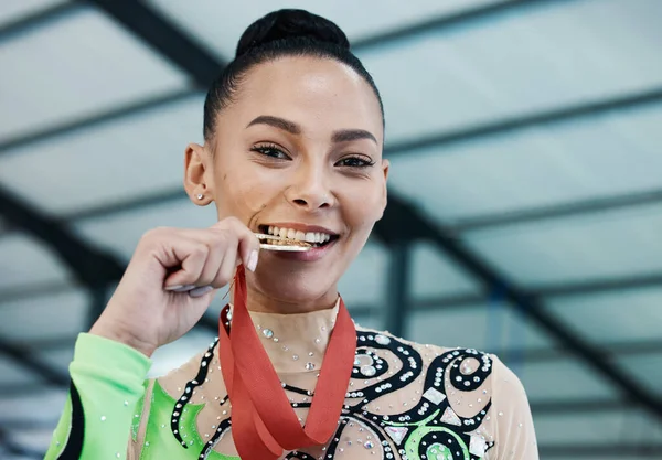 Medal, winner and portrait of woman with success in competition, gymnastics or gold, award and prize from achievement in tournament. Winning, athlete and celebration on podium in stadium or arena.