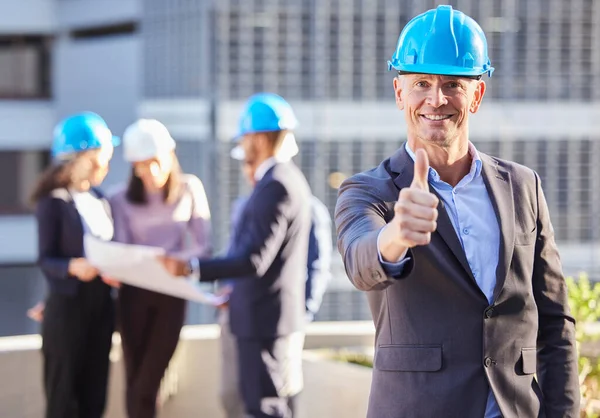 Businessman, architect and thumbs up in construction for success, winning or teamwork on site. Portrait of happy man or engineer smile with thumb emoji, yes sign or like for approval in architecture.