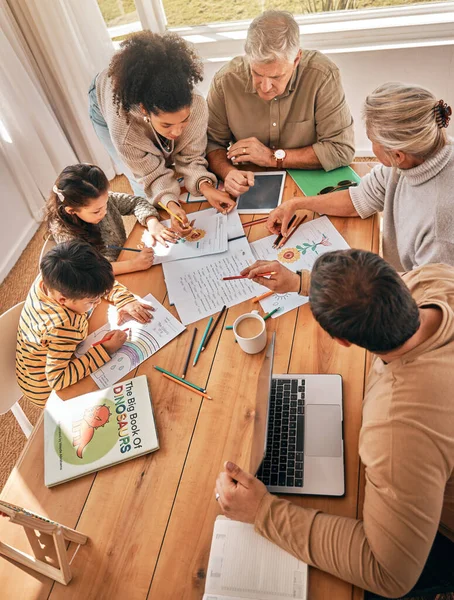 Family home, kids and homework with learning, grandparents and parents with tech in top view. Mother, father and children with laptop, tablet and paperwork in busy house with help, reading or study.