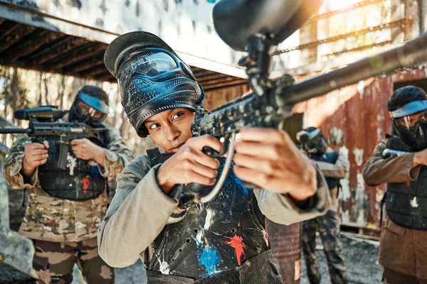 Paintball team, gun and woman aim, focus and shooting at target practice, competition or military conflict, fight or mission. Group, soldier or people point weapon in survival war, training or battle.